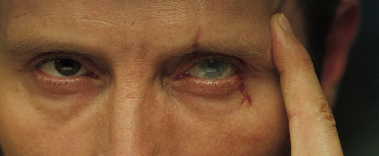Closeup of Mads Mikkelsen's eyes as Le Chiffre, the right one is brown, the left one is clouded and crossed by a scar